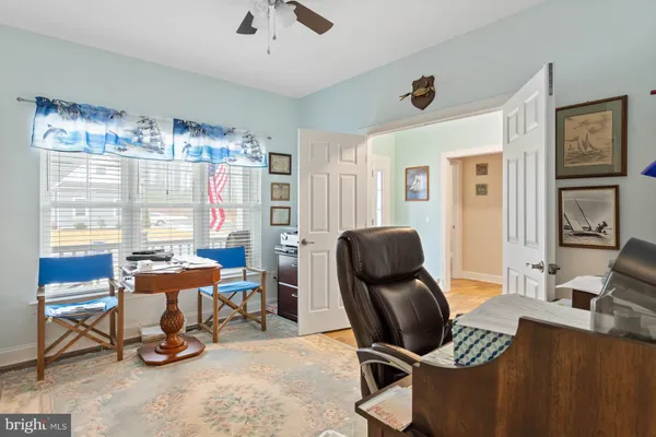 a living room with furniture chandelier and a window