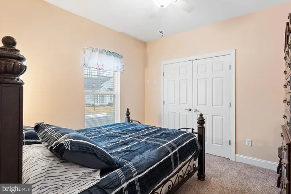 a bedroom with a large bed and a flat tv screen