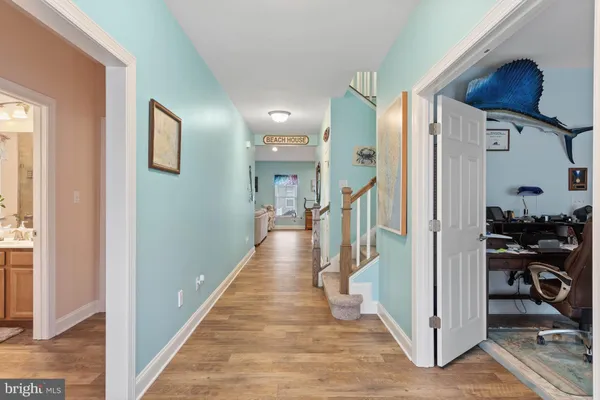 a view of a hallway with a livingroom and entryway