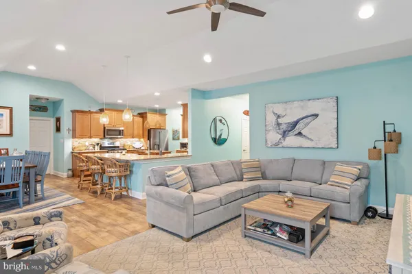 a living room with furniture and kitchen view
