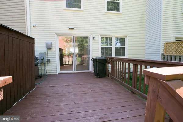 a view of a deck with wooden floor and a wooden fence