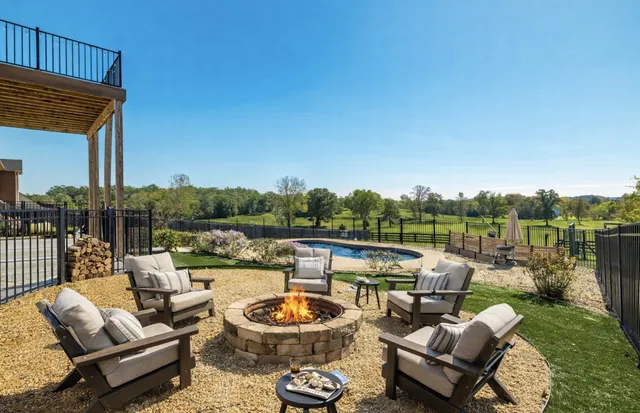a view of a patio with couches chairs and a fire pit