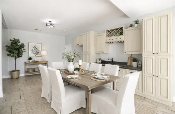 a view of a dining room with furniture and a chandelier