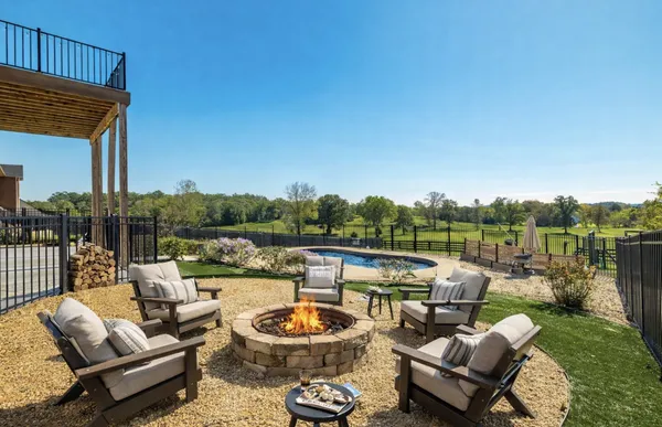 a view of a patio with couches chairs and a fire pit