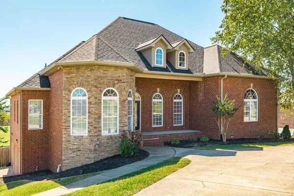 a front view of a house with garden