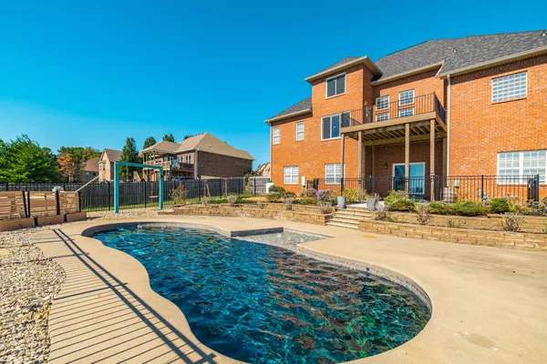 a view of a house with swimming pool and sitting area