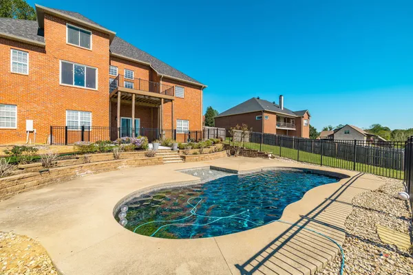 a view of a swimming pool with a lounge chairs