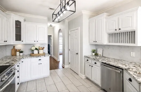 a kitchen with stainless steel appliances granite countertop a sink and cabinets