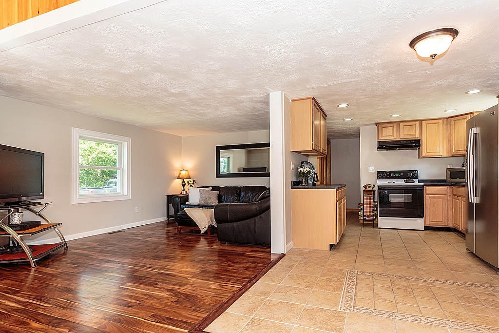9 Arbor Road Chelmsford, MA 01863 - Photo 14 of 25 a living room with furniture a dining table and kitchen view