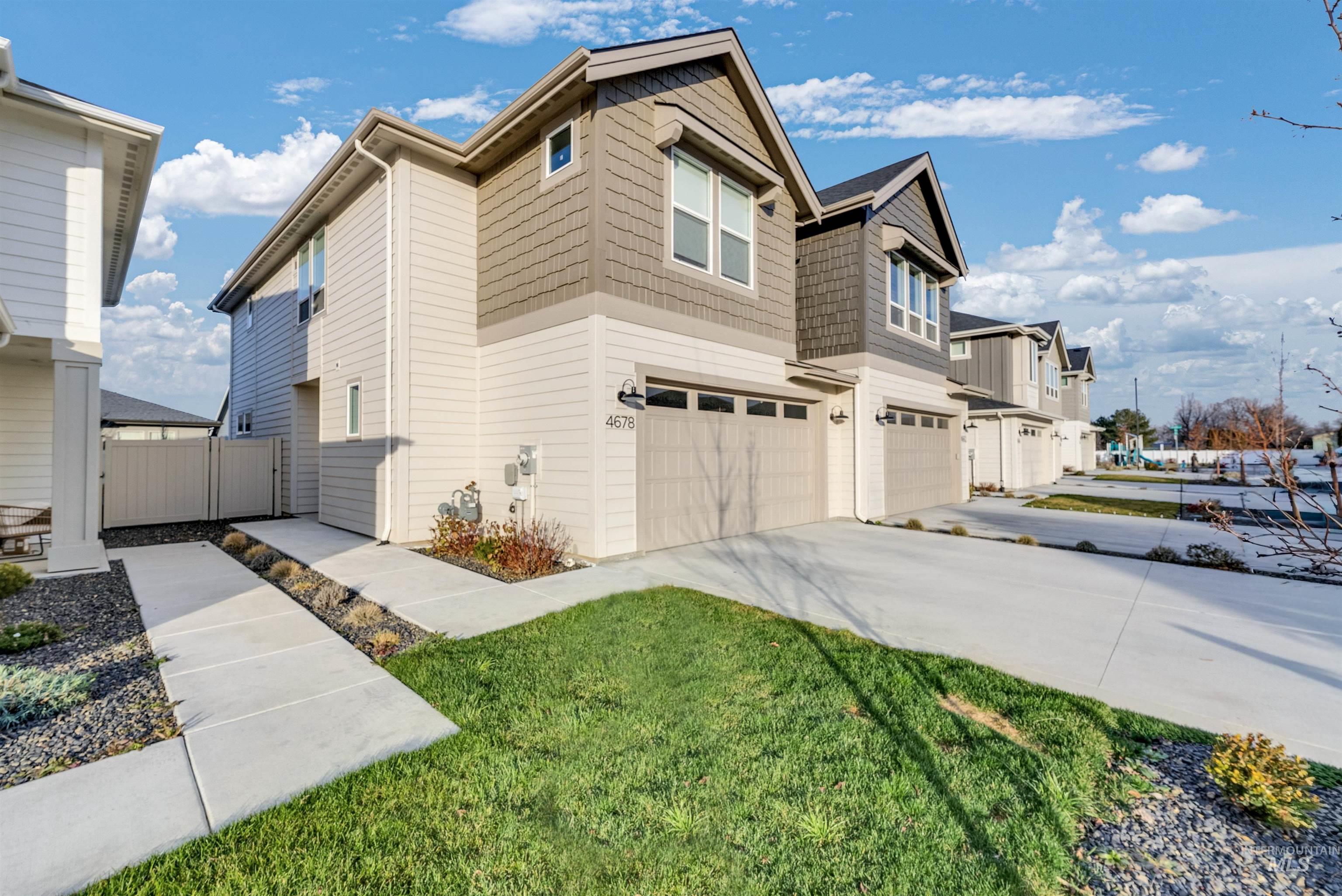 View of side of home featuring concrete driveway and a garage