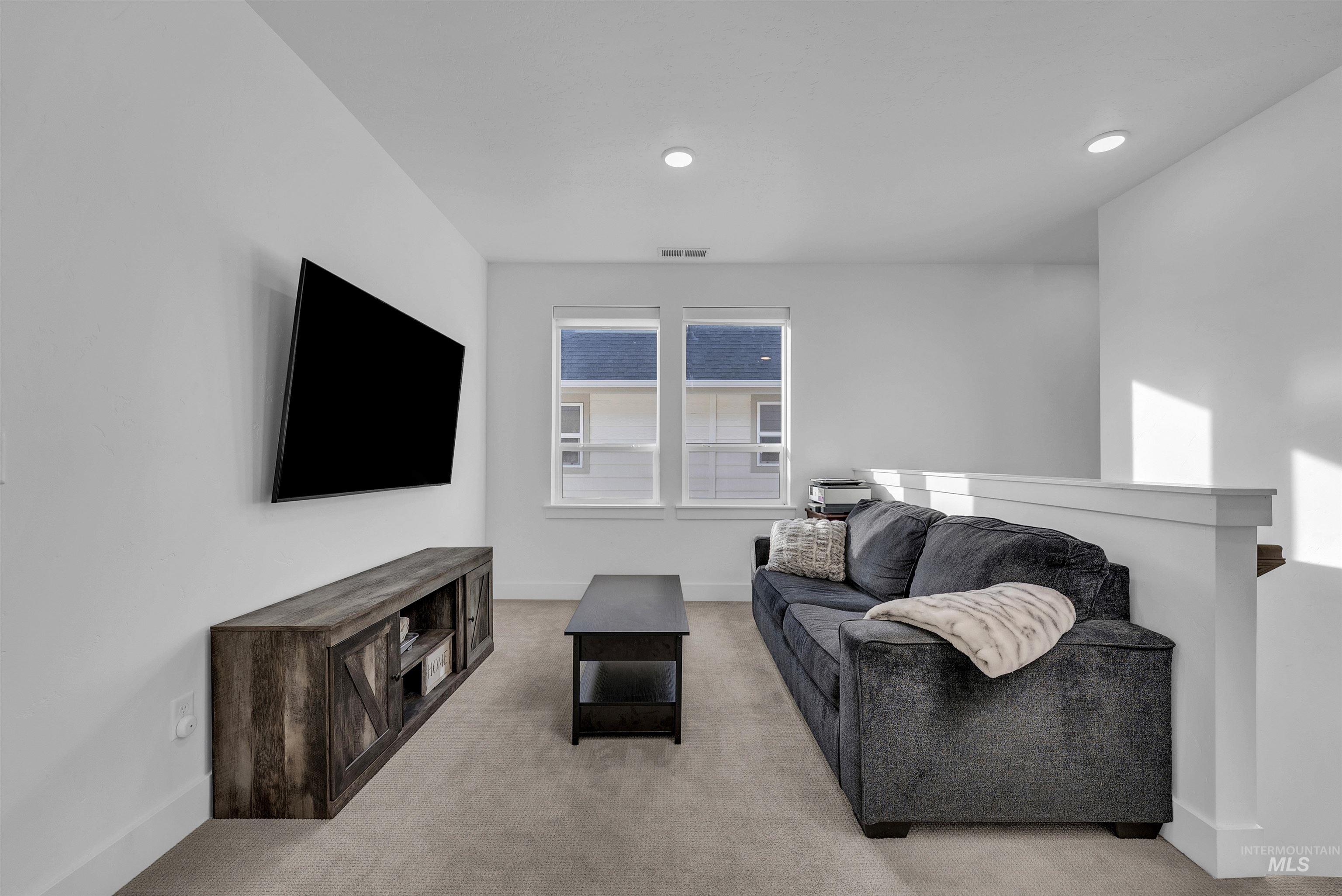 4678 West Riva Capri Street Meridian, ID 83646 - Photo 12 of 30 Loft with light colored carpet and recessed lighting