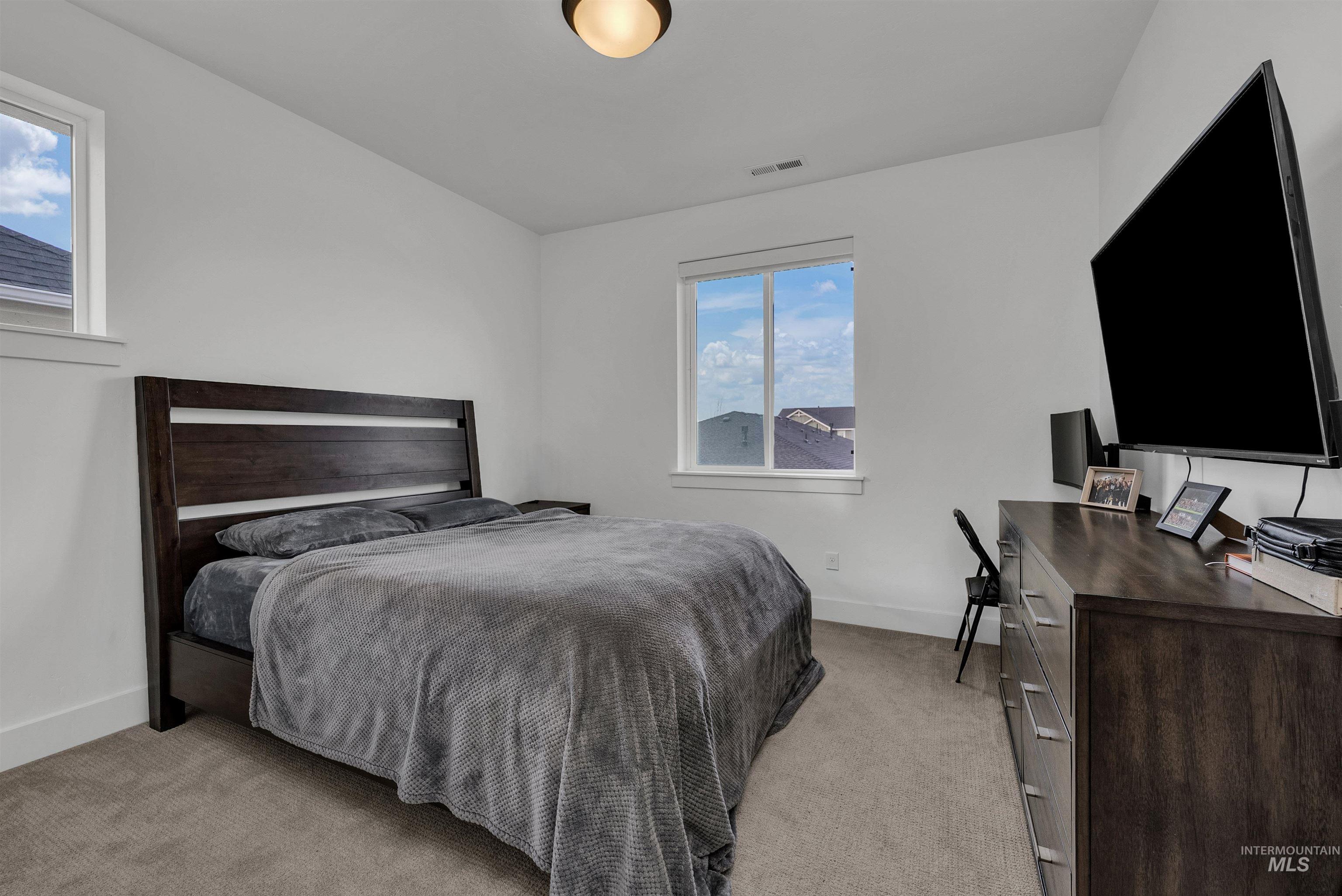4678 West Riva Capri Street Meridian, ID 83646 - Photo 18 of 30 Bedroom featuring light carpet and baseboards