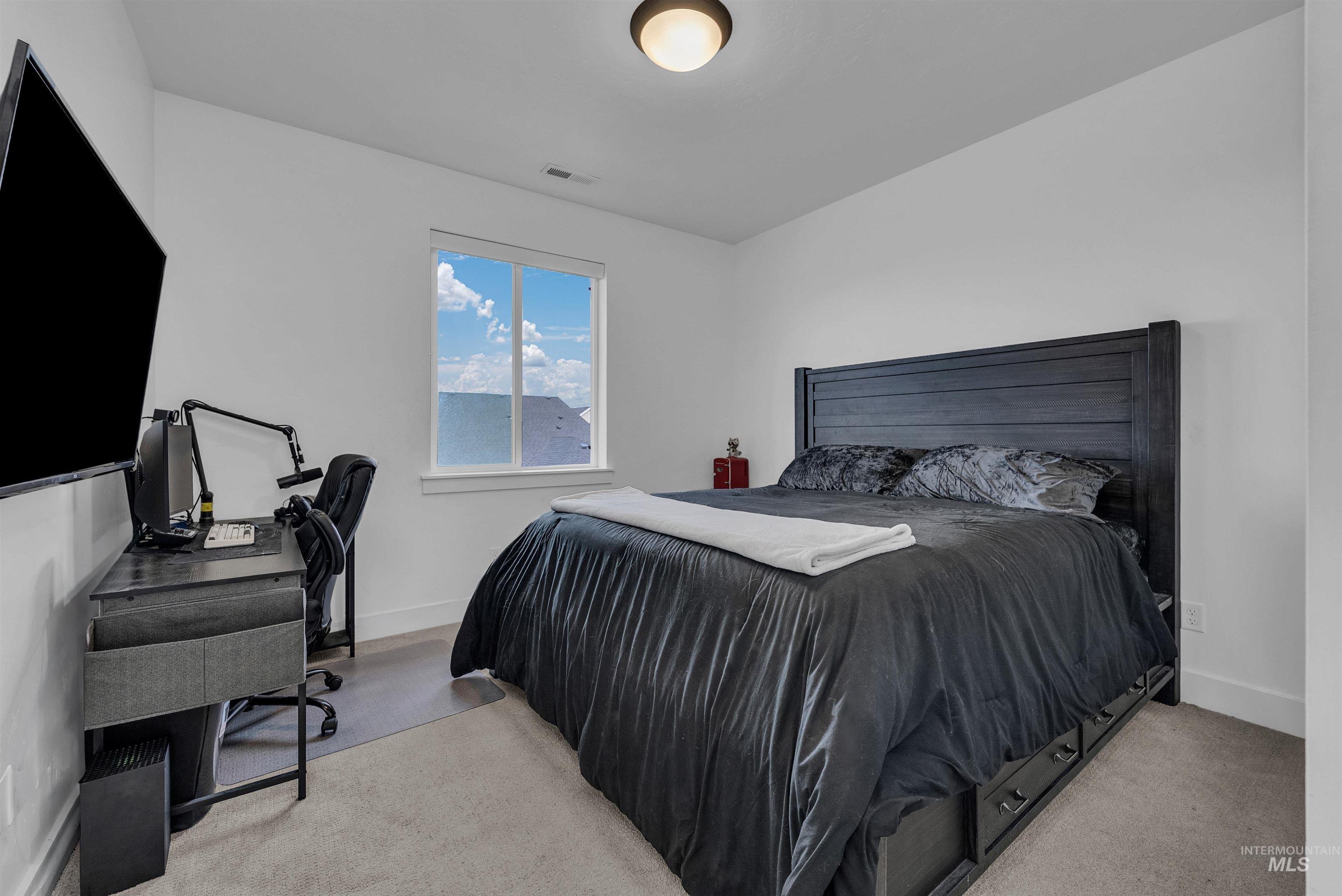 4678 West Riva Capri Street Meridian, ID 83646 - Photo 19 of 30 Bedroom with a desk and light colored carpet