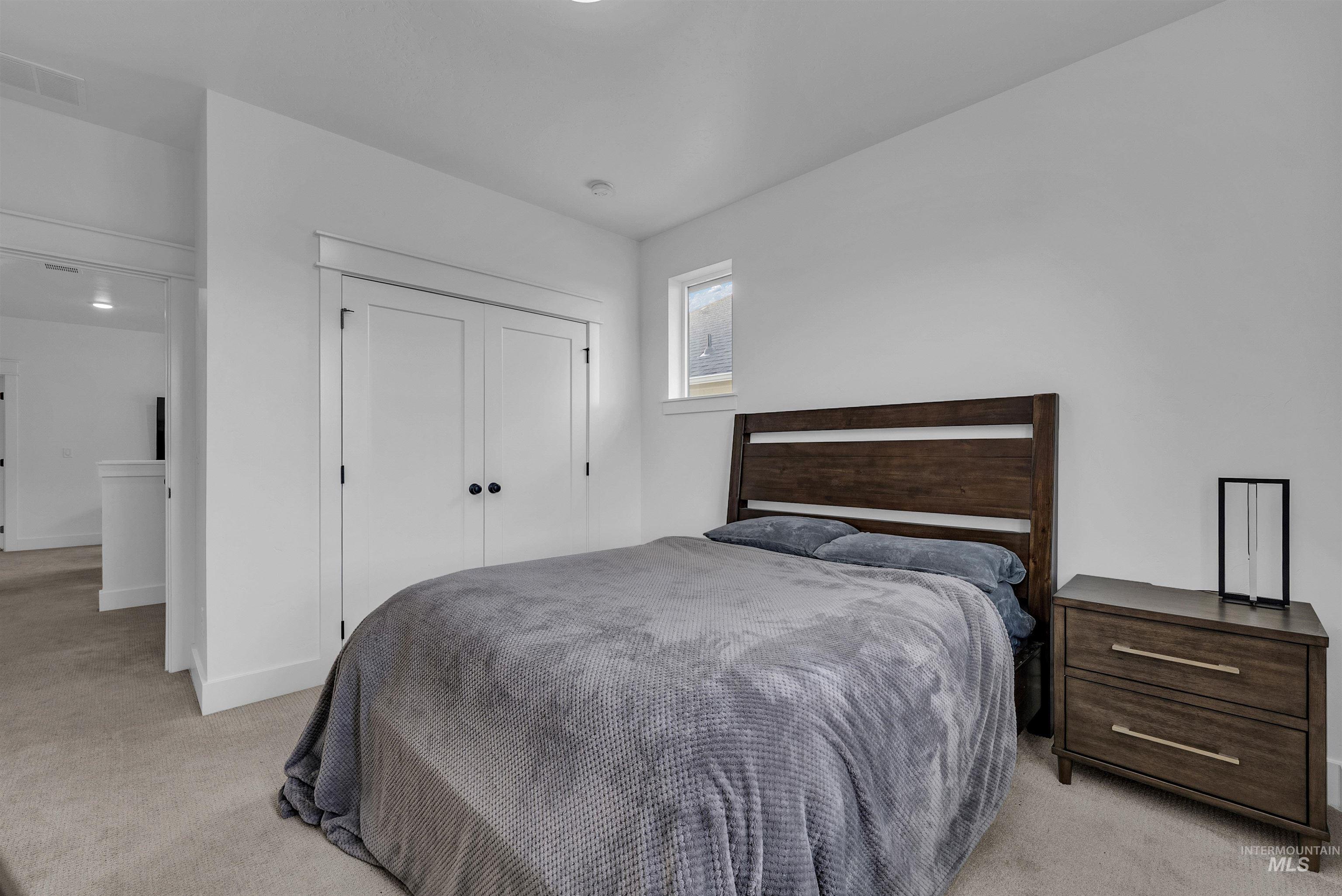 4678 West Riva Capri Street Meridian, ID 83646 - Photo 21 of 30 Bedroom with light colored carpet and a closet