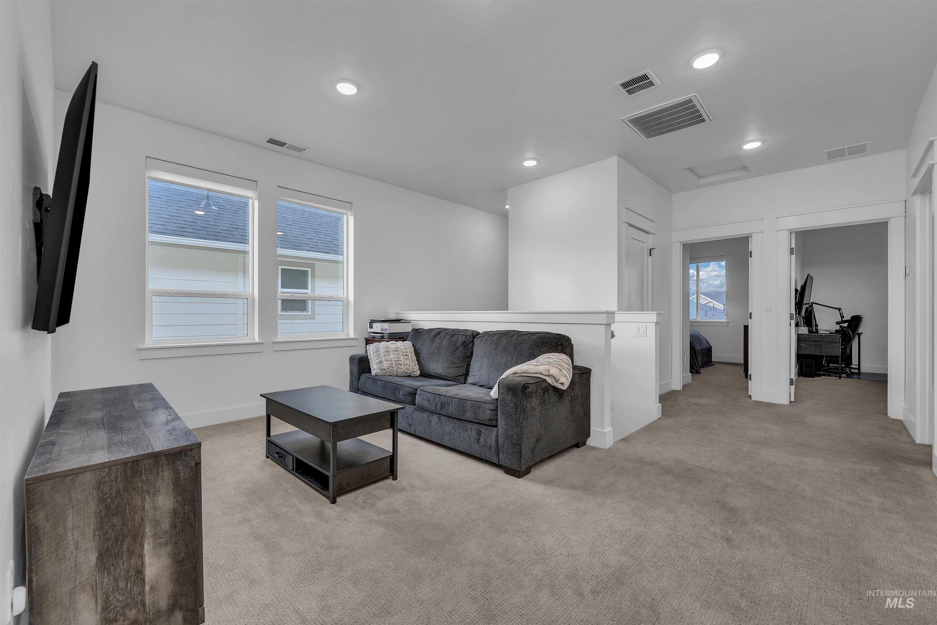 4678 West Riva Capri Street Meridian, ID 83646 - Photo 24 of 30 Living area with light carpet and recessed lighting