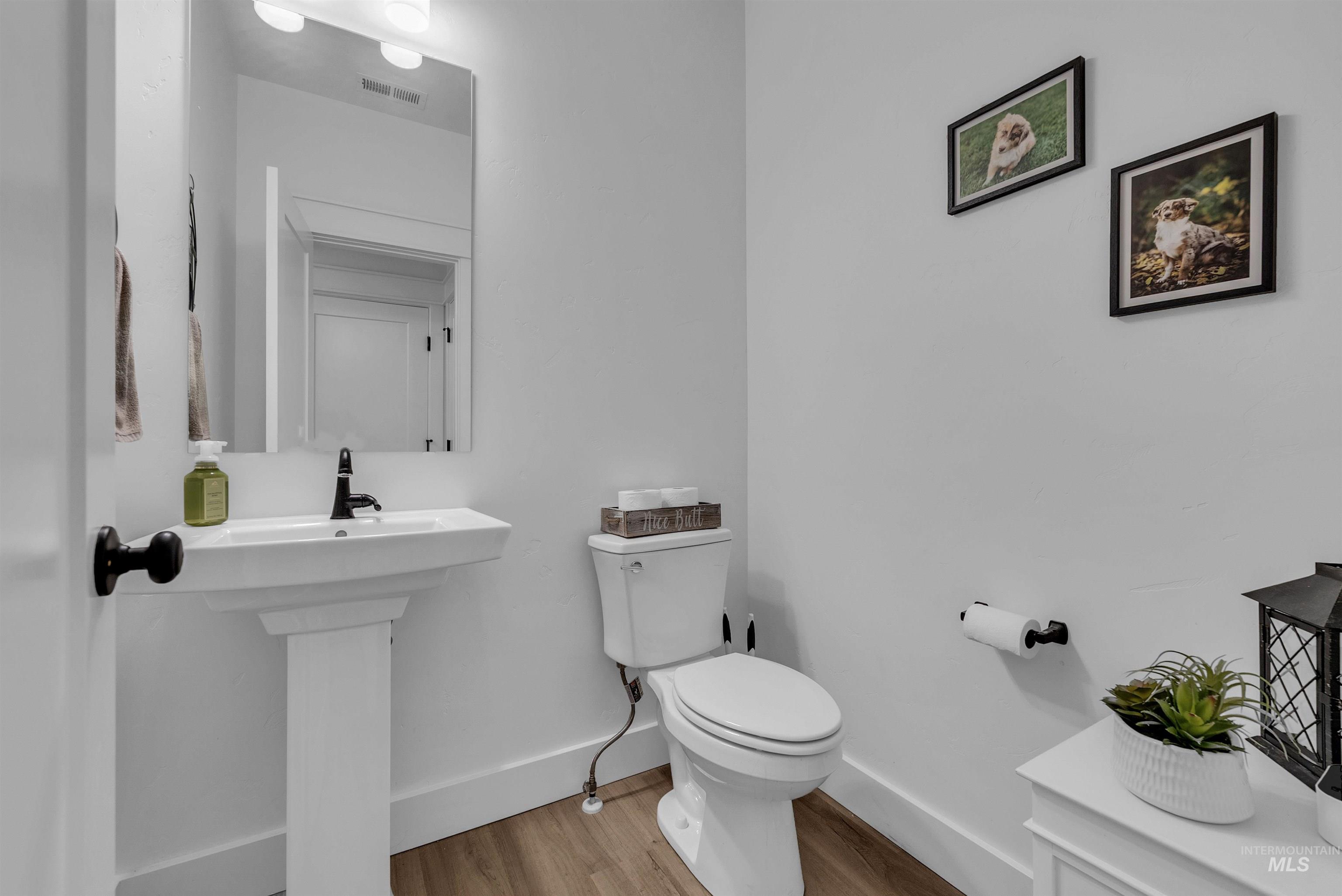 4678 West Riva Capri Street Meridian, ID 83646 - Photo 25 of 30 Bathroom featuring baseboards and wood finished floors