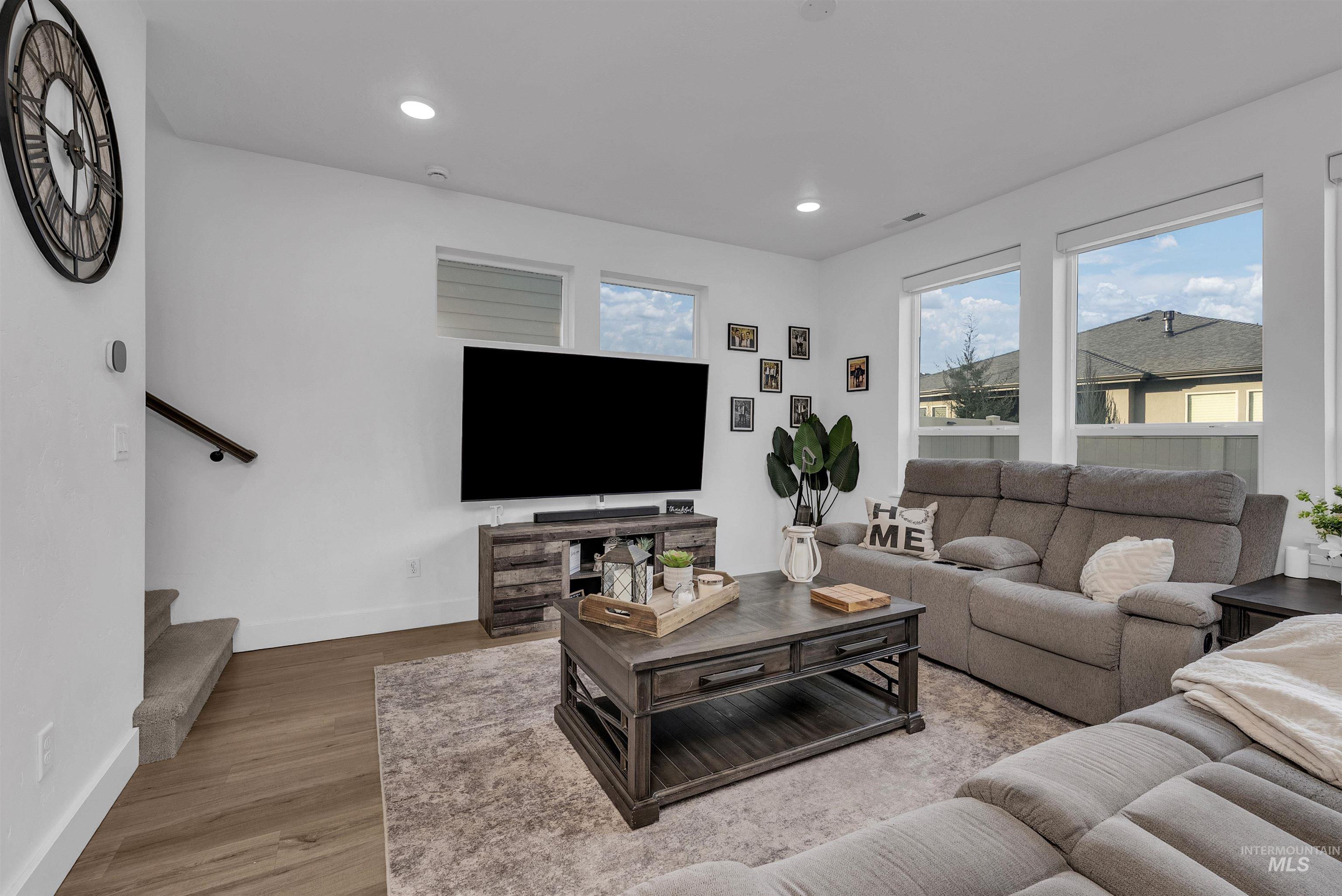 4678 West Riva Capri Street Meridian, ID 83646 - Photo 9 of 30 Living area with light wood-style floors, recessed lighting, and stairway