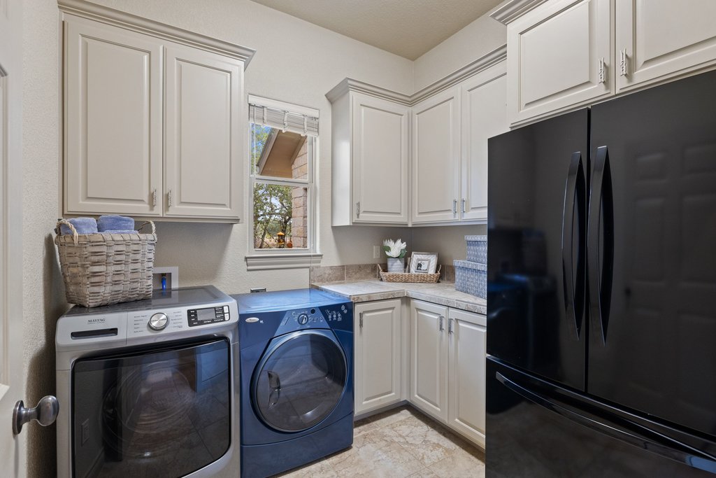 232 Crooked Oak Round Mountain, TX 78663 - Photo 27 of 40 Laundry area with washing machine and dryer and cabinet space