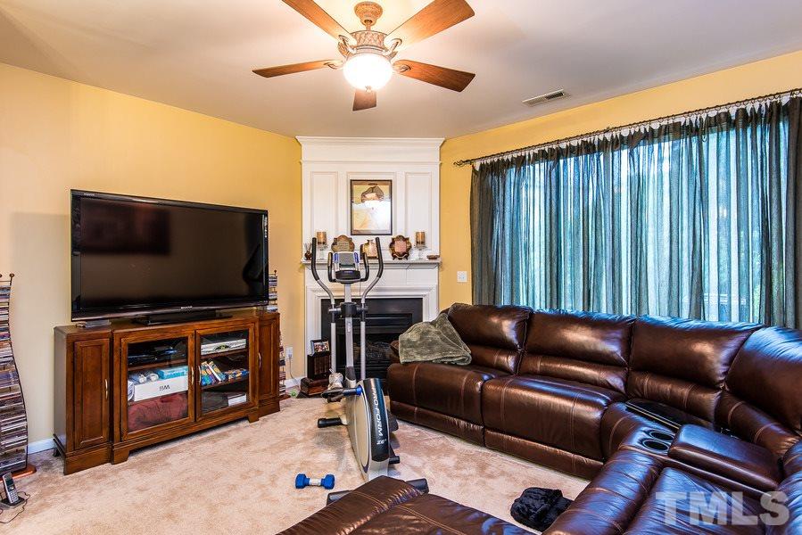 1732 Sorrell Brook Way Raleigh, NC 27609 - Photo 8 of 15 a living room with furniture and a flat screen tv