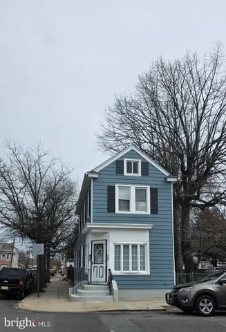 a front view of a building with trees