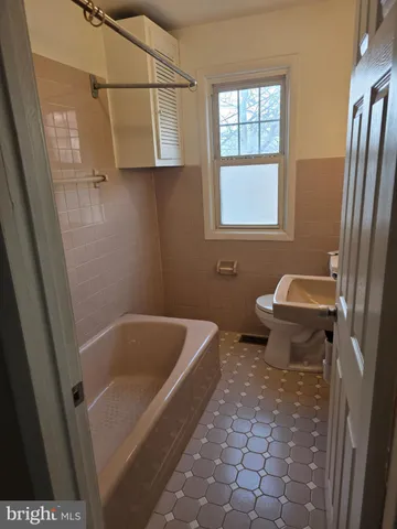 a bathroom with a tub and window