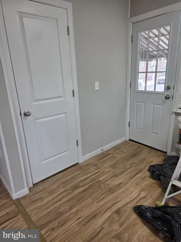 a view of a room with wooden floor and cabinet