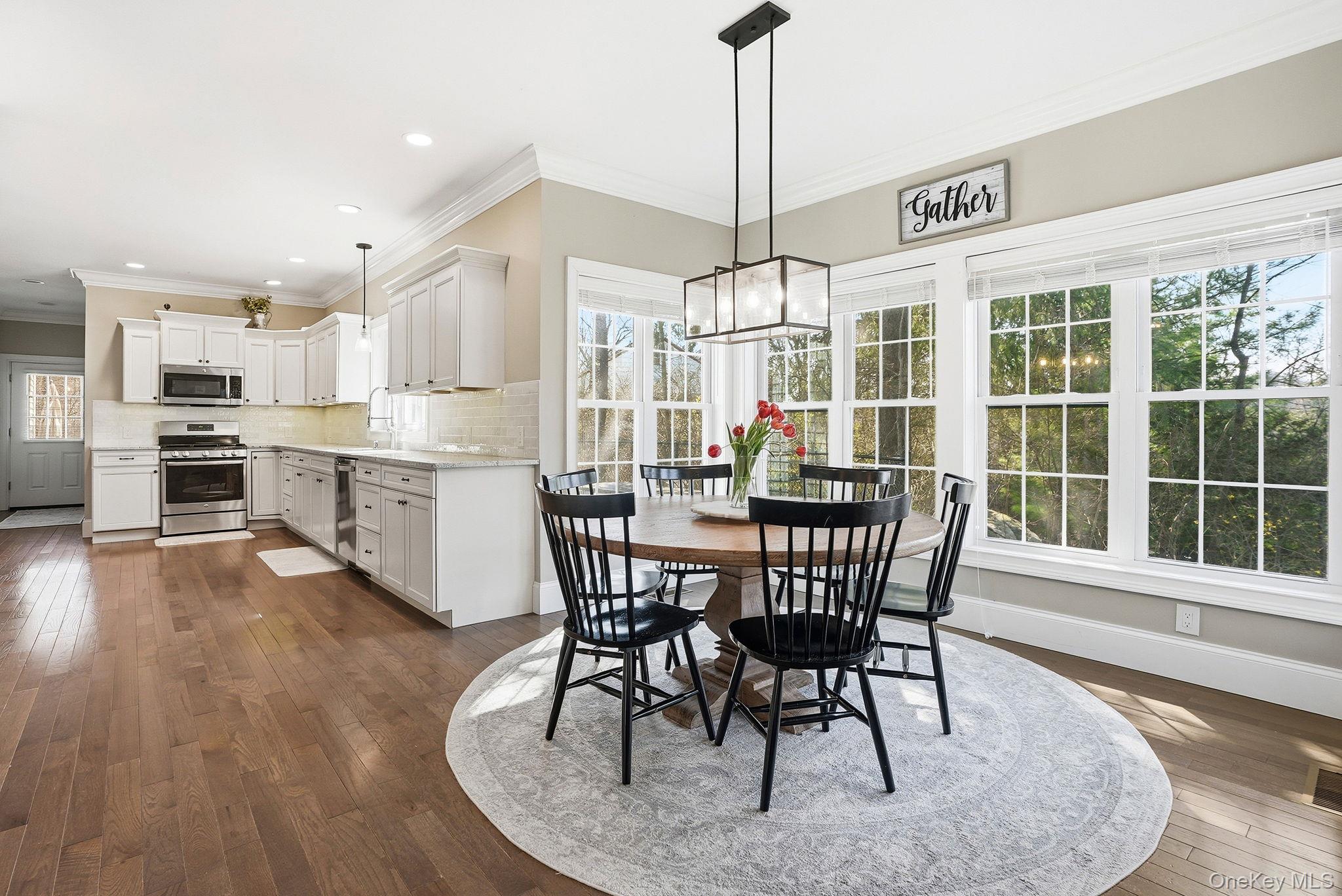 19 Lillian Road Mahopac, NY 10541 - Photo 13 of 50 Dining area with ornamental molding, dark wood-type flooring, and hanging lights