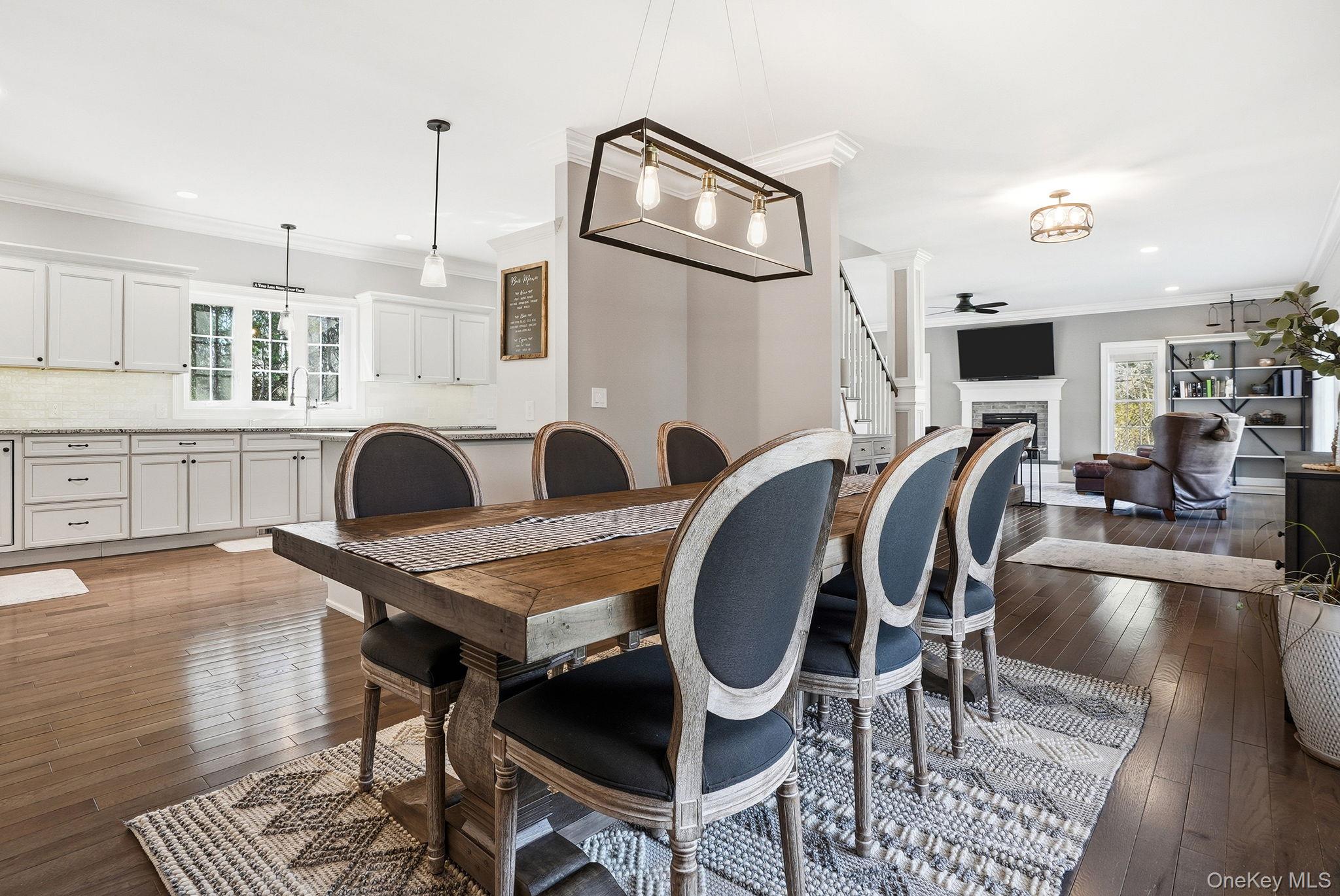 19 Lillian Road Mahopac, NY 10541 - Photo 15 of 50 Dining area featuring a fireplace, dark wood-type flooring, crown molding, a ceiling fan, and recessed lighting