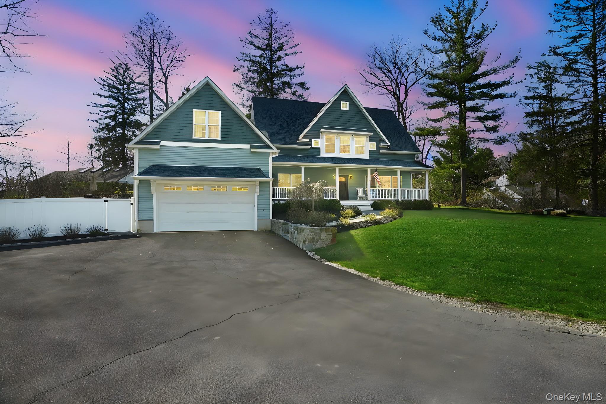 19 Lillian Road Mahopac, NY 10541 - Photo 2 of 50 View of front of home featuring covered porch, asphalt driveway, a garage, and a gate