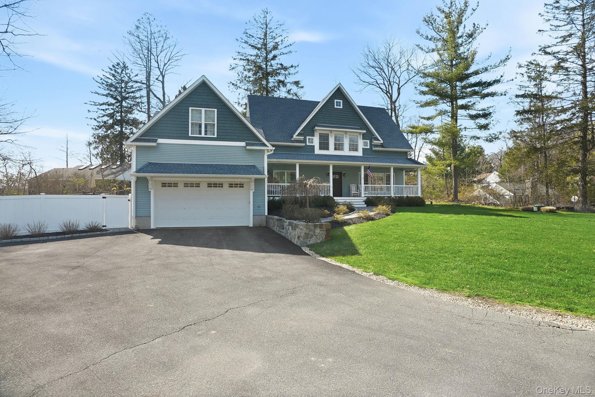 19 Lillian Road Mahopac, NY 10541 - Photo 3 of 50 View of front of home with a porch, asphalt driveway, and an attached garage