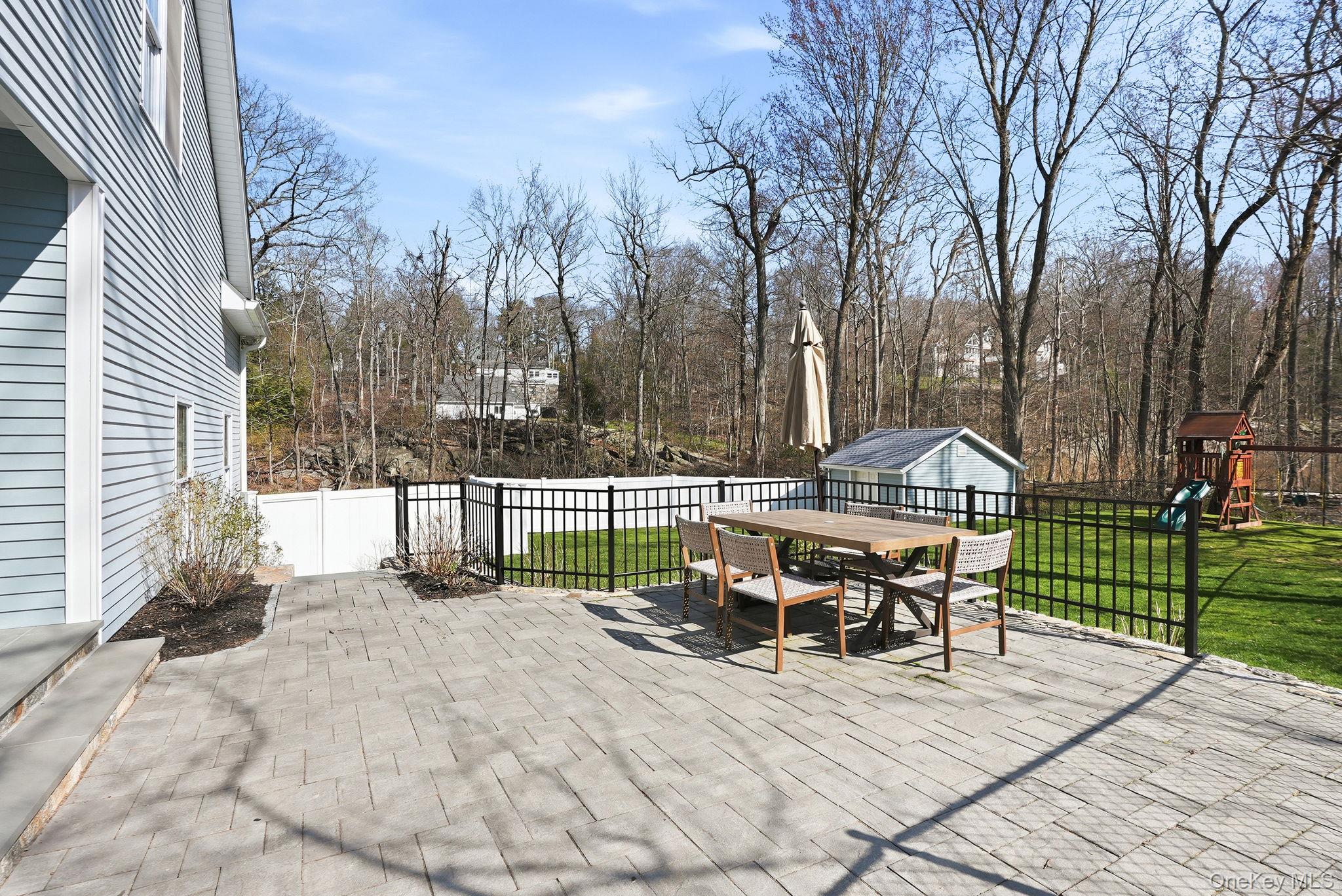 19 Lillian Road Mahopac, NY 10541 - Photo 38 of 50 Fenced backyard featuring outdoor dining space, a patio, an outbuilding, and a playground