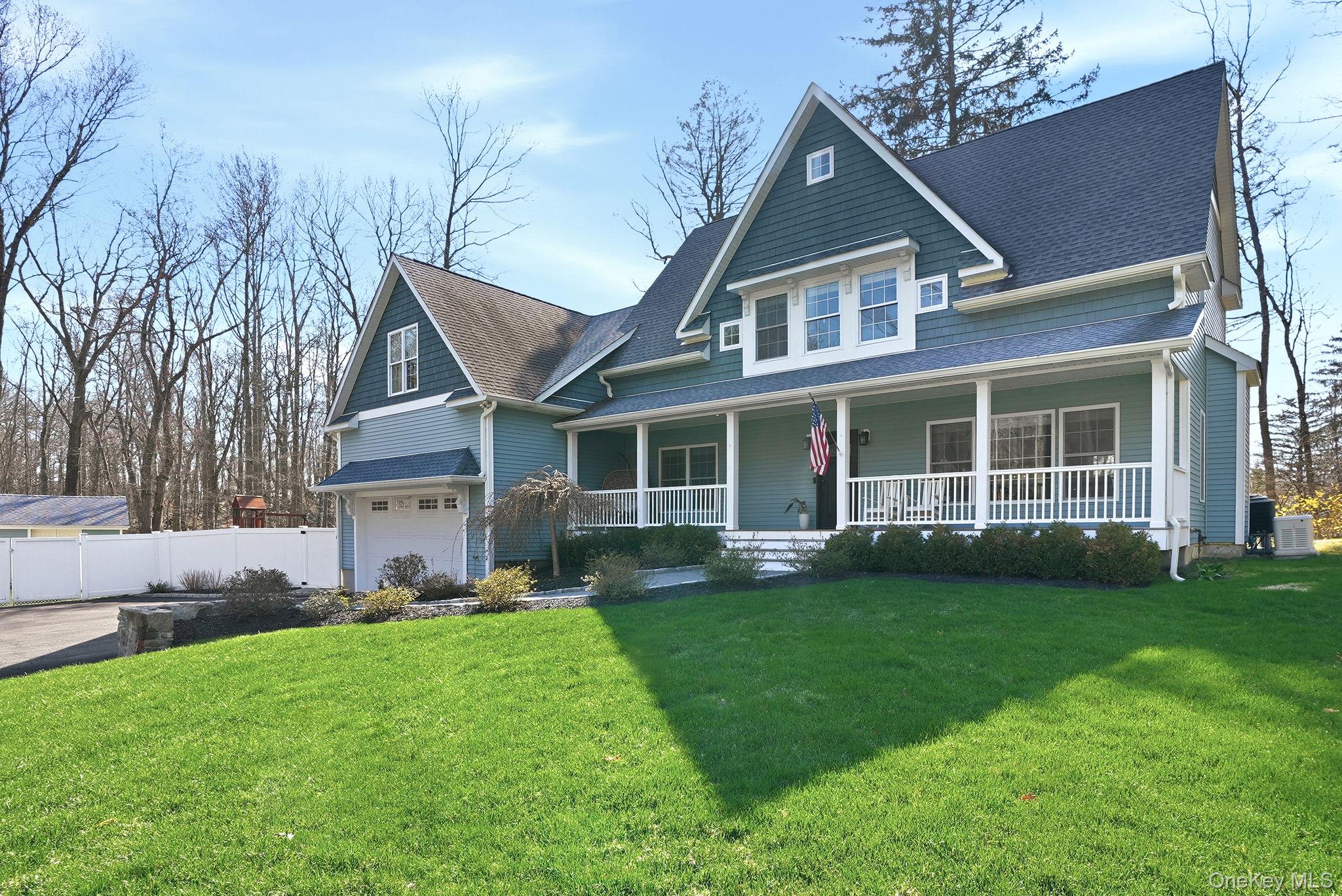 19 Lillian Road Mahopac, NY 10541 - Photo 4 of 50 View of front of house with a porch, a garage, and a shingled roof