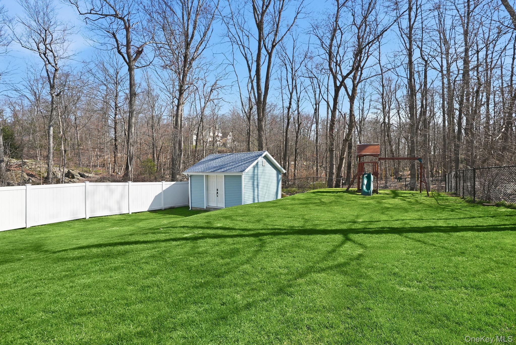 19 Lillian Road Mahopac, NY 10541 - Photo 45 of 50 Fenced backyard featuring a playground and a shed