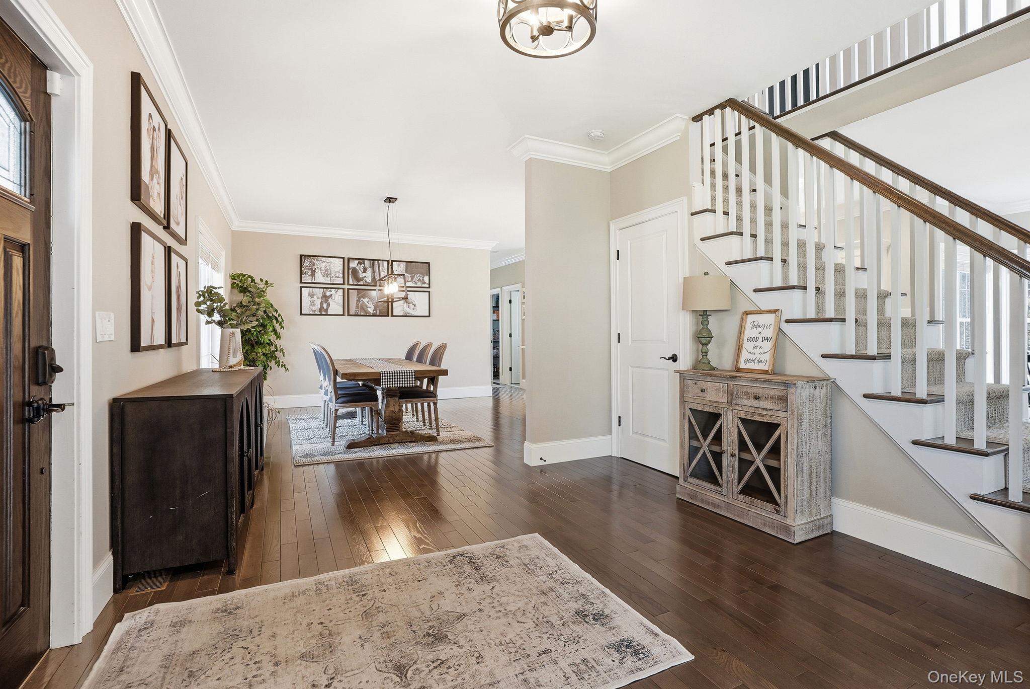 19 Lillian Road Mahopac, NY 10541 - Photo 9 of 50 Entrance foyer featuring dark wood-type flooring, crown molding, and suspended lighting
