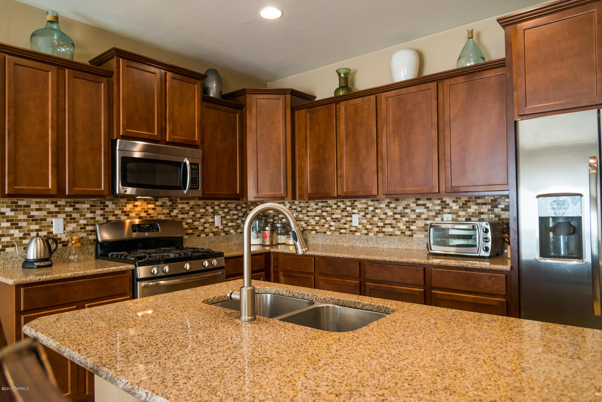 4405 West Crystal Ranch Place Marana, AZ 85658 - Photo 4 of 44 a kitchen with granite countertop a stove and a sink
