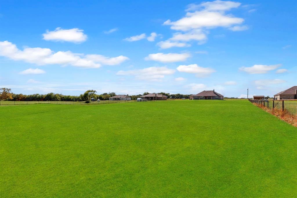 634 Gant Road Sherman, TX 75090 - Photo 33 of 40 Expansive green lawn with a wire fence lining the property boundary