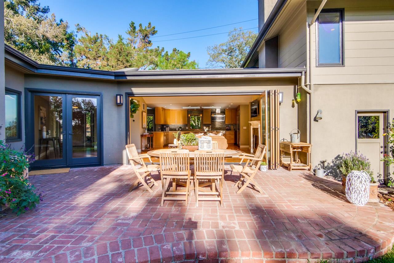 10551 Magdalena Road Los Altos Hills, CA 94024 - Photo 18 of 45 a view of a patio with table and chairs potted plants with wooden floor