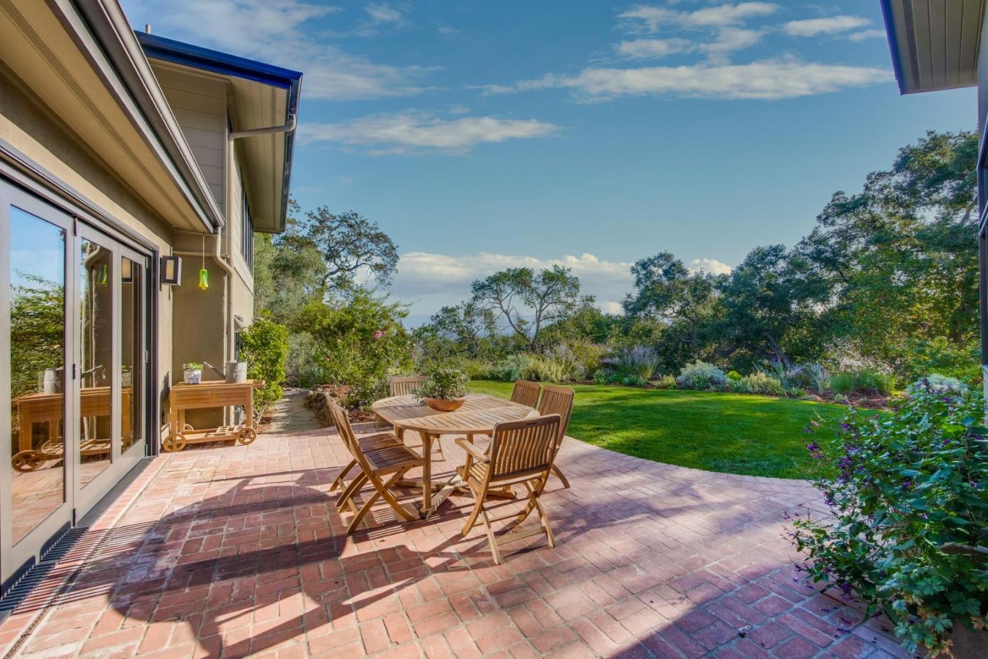 10551 Magdalena Road Los Altos Hills, CA 94024 - Photo 19 of 45 a view of a patio with a table and chairs