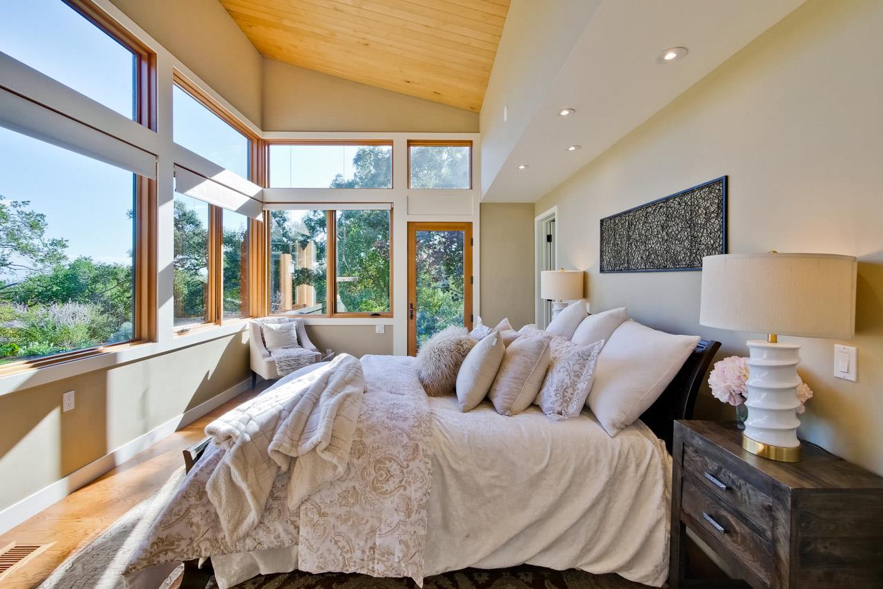 10551 Magdalena Road Los Altos Hills, CA 94024 - Photo 21 of 45 a bedroom with a bed and glass windows