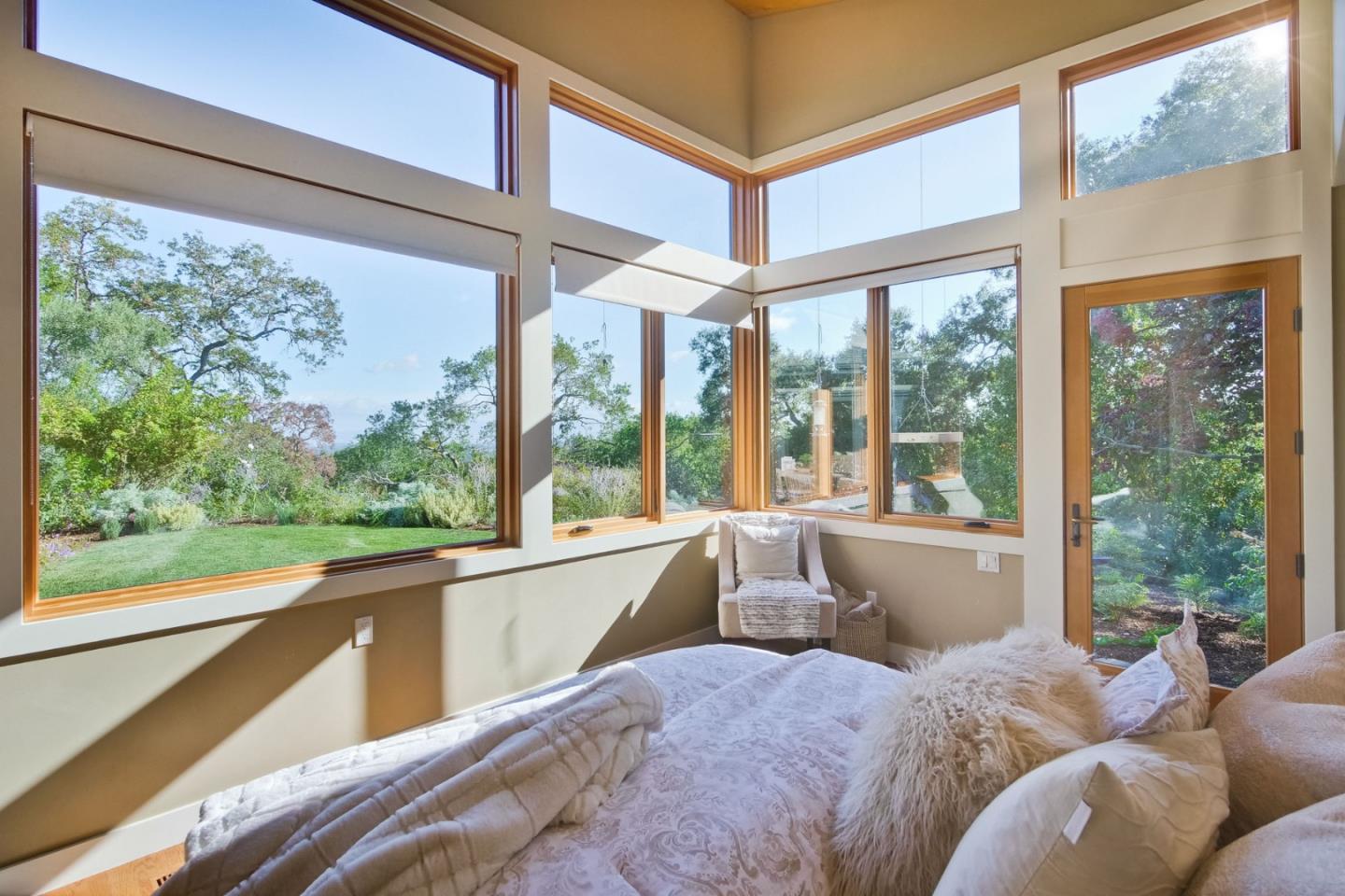 10551 Magdalena Road Los Altos Hills, CA 94024 - Photo 22 of 45 a living room with a large window and a bed