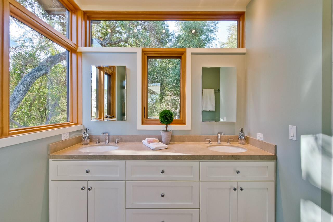 10551 Magdalena Road Los Altos Hills, CA 94024 - Photo 23 of 45 a bathroom with a double vanity sink and mirror with large window