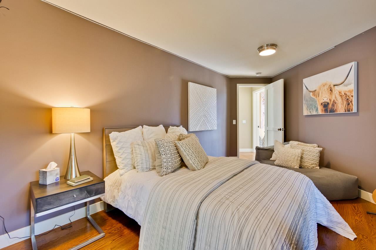 10551 Magdalena Road Los Altos Hills, CA 94024 - Photo 32 of 45 a bedroom with a bed and lamp