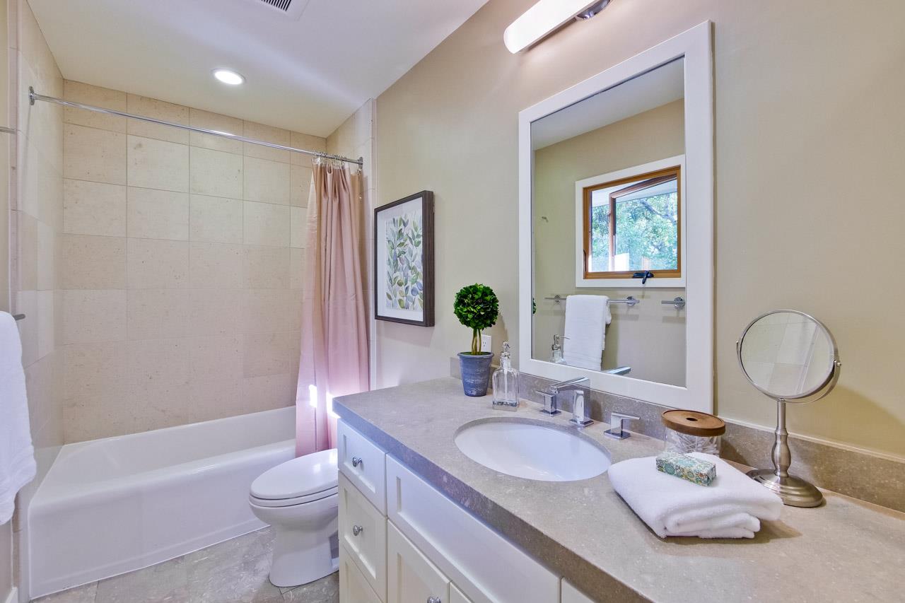 10551 Magdalena Road Los Altos Hills, CA 94024 - Photo 33 of 45 a bathroom with a granite countertop sink toilet and mirror