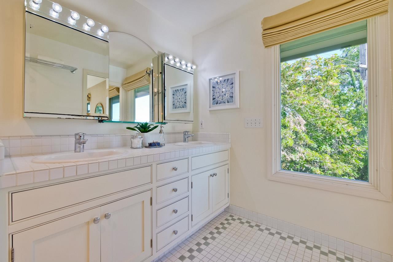 10551 Magdalena Road Los Altos Hills, CA 94024 - Photo 38 of 45 a bathroom with a double vanity sink and a mirror