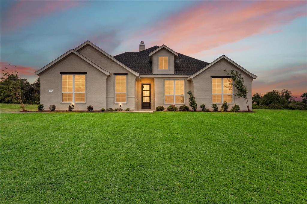 317 Skeen Peak Springtown, TX 76082 - Photo 1 of 31 Contemporary single-story residence with a light brick exterior and dark shingle roof