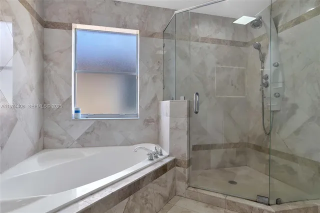 a bathroom with a bathtub and a shower