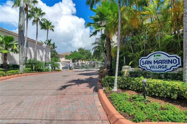 a sign board with a park on both side of the road