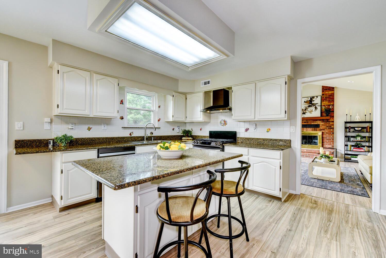 5 Glengarry Way Princeton Junction, NJ 08550 - Photo 21 of 63 a kitchen with a table chairs a sink dishwasher stove and cabinets with wooden floor