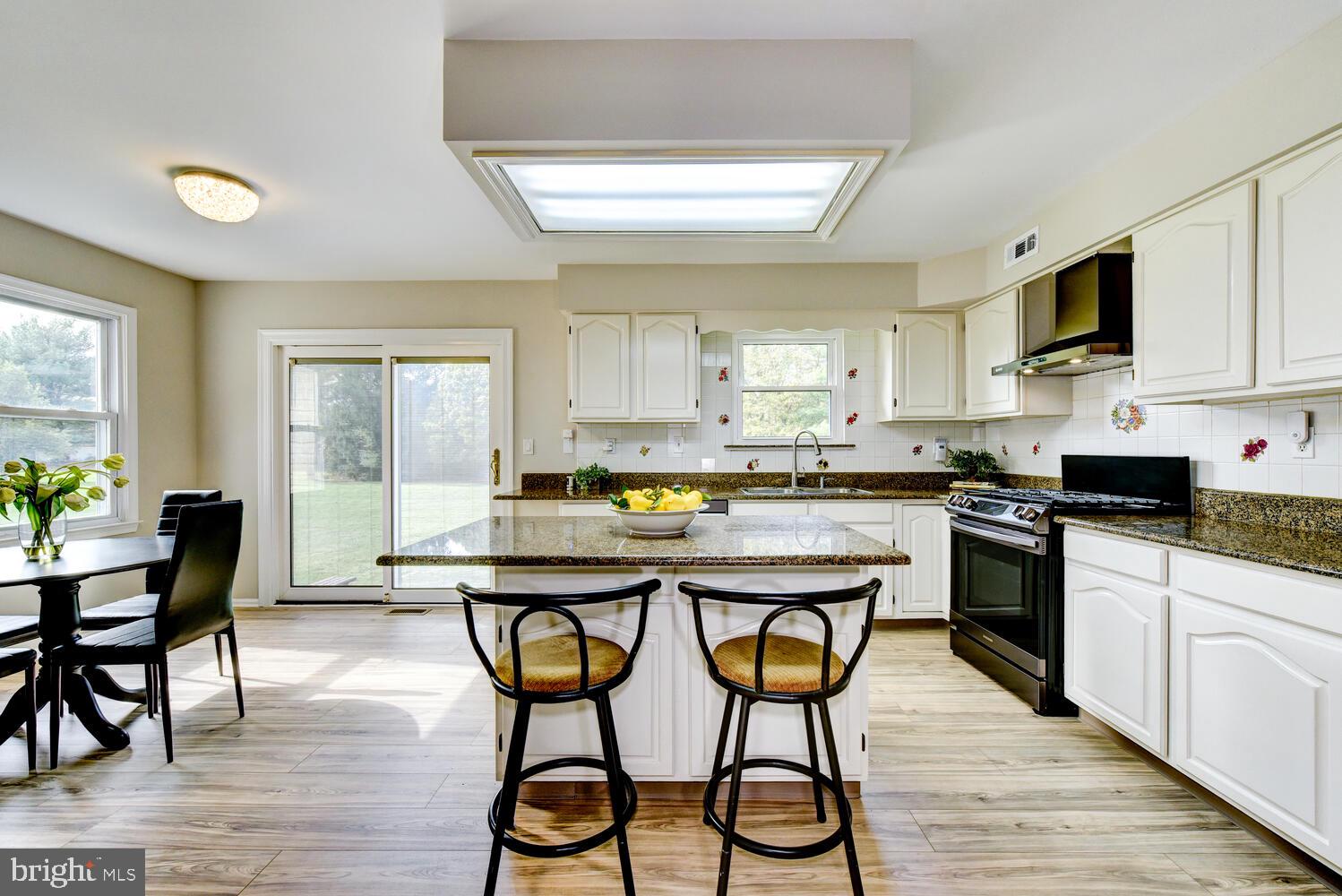 5 Glengarry Way Princeton Junction, NJ 08550 - Photo 22 of 63 a kitchen with stainless steel appliances granite countertop wooden floor a center island and cabinets