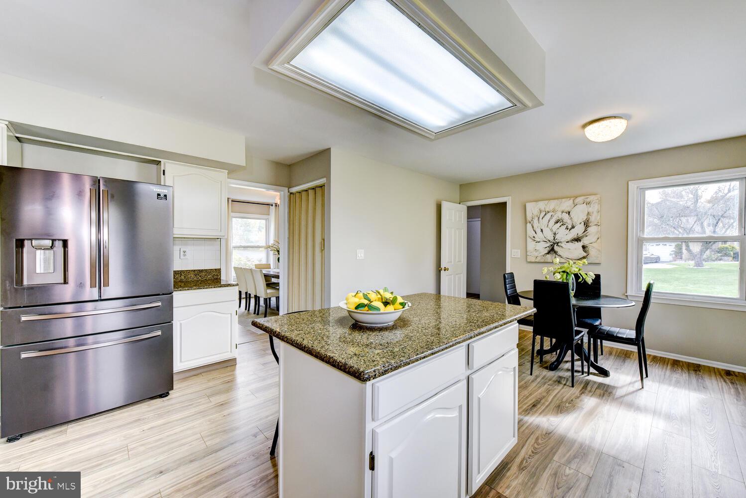5 Glengarry Way Princeton Junction, NJ 08550 - Photo 27 of 63 a kitchen with granite countertop stainless steel appliances a dining table and chairs
